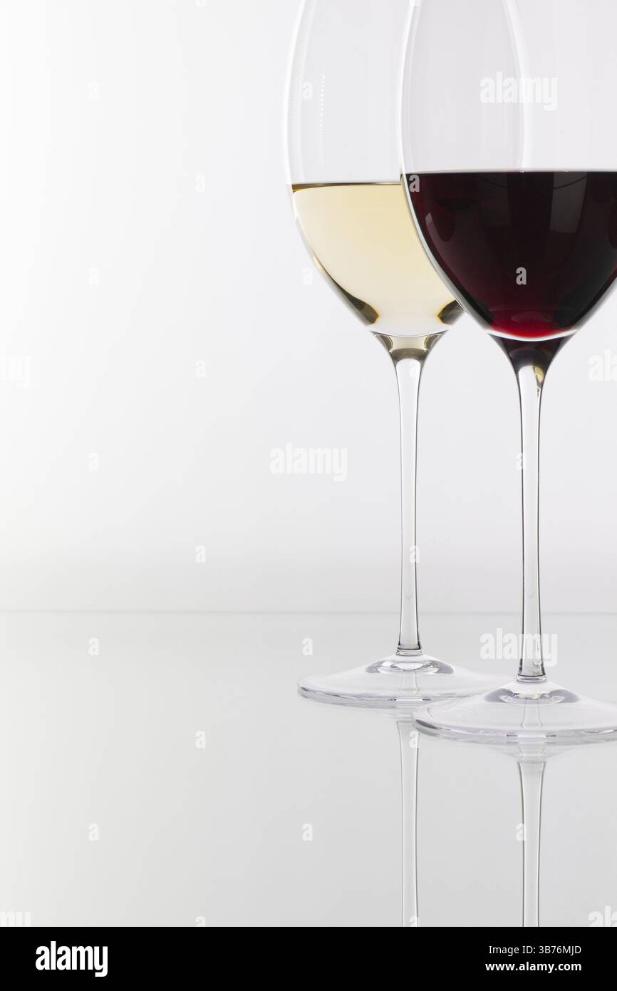 Weinglas mit rot- und Weißwein auf einem Glastisch Stockfoto