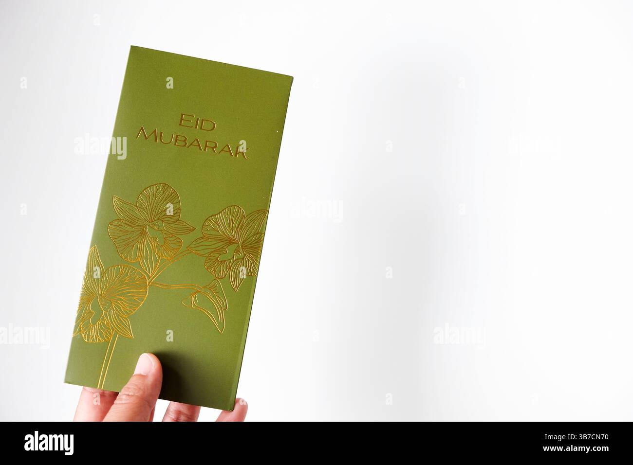 Hand hält THR-Umschlag. DIE Urlaubszulage für Eid al-Fitr- oder Lebaran-Tage ist gültig. Stockfoto
