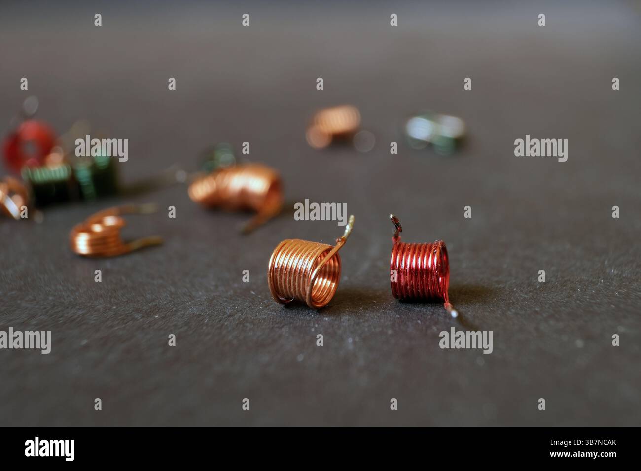 Kupferspulen mit lackierten Außenflächen. Kupferwicklungen, die in elektrischen Stromkreisen verwendet werden. Stockfoto