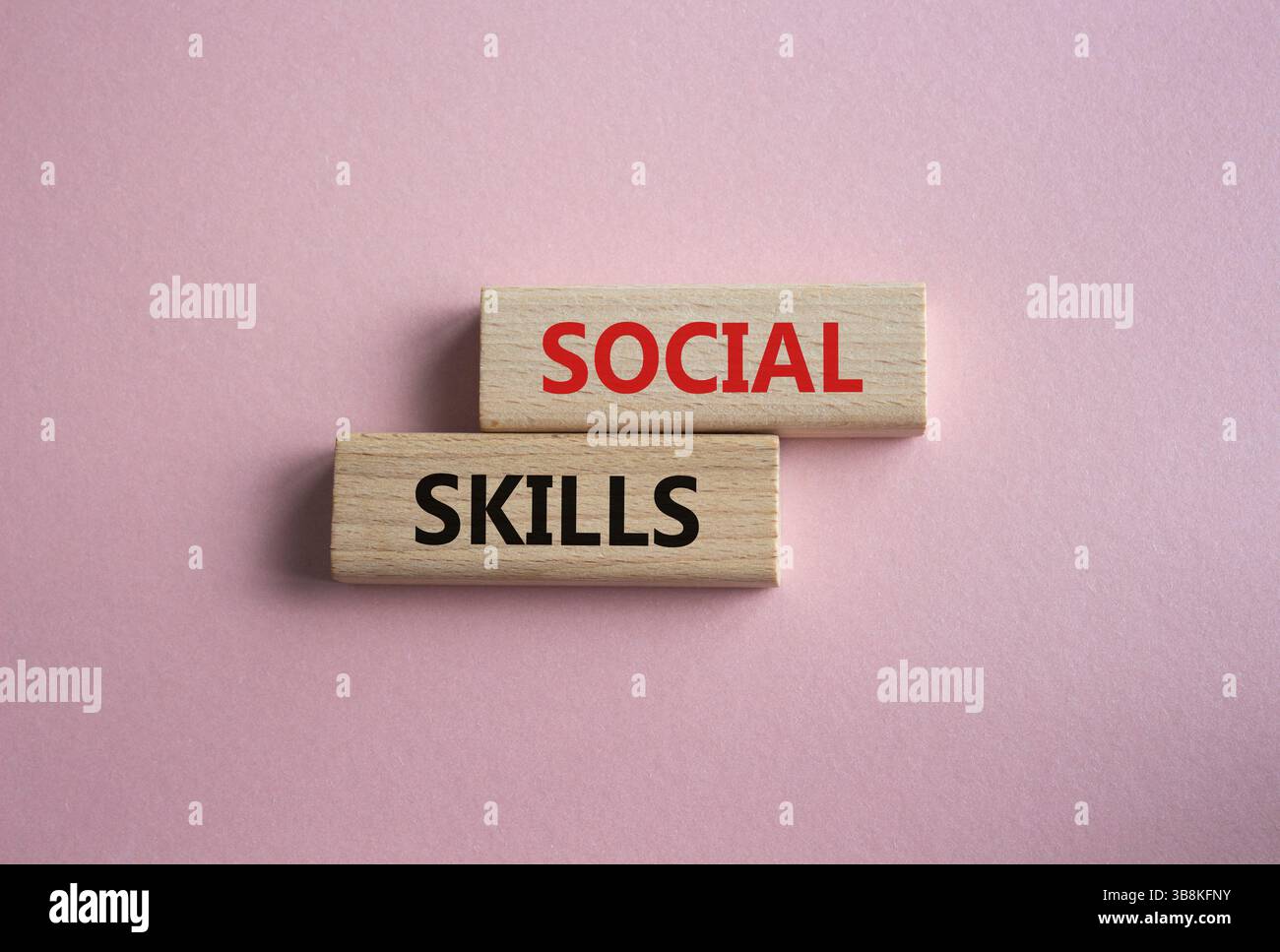 Symbol für soziale Kompetenzen. Holzblöcke mit Worten soziale Fähigkeiten schöner rosafarbener Hintergrund. Konzept der unternehmerischen und sozialen Kompetenzen. Kopierbereich. Stockfoto