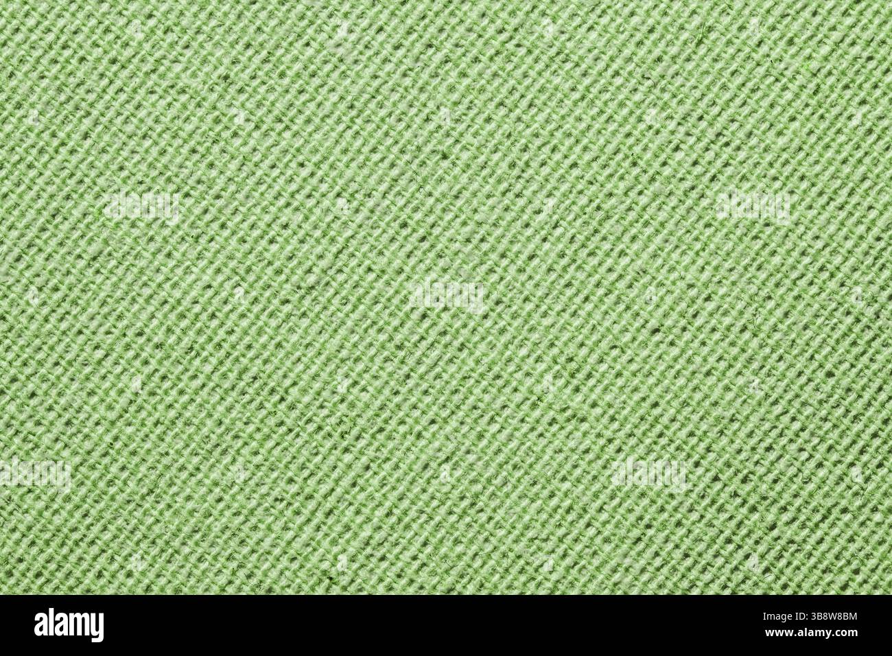 Grüne Stoffstruktur. Nahaufnahme weicher Textiloberflächen. Diagonale Linien im Strickmuster. Hintergrund bereinigen. Einfaches Material für Mode oder Polsterung. Stockfoto