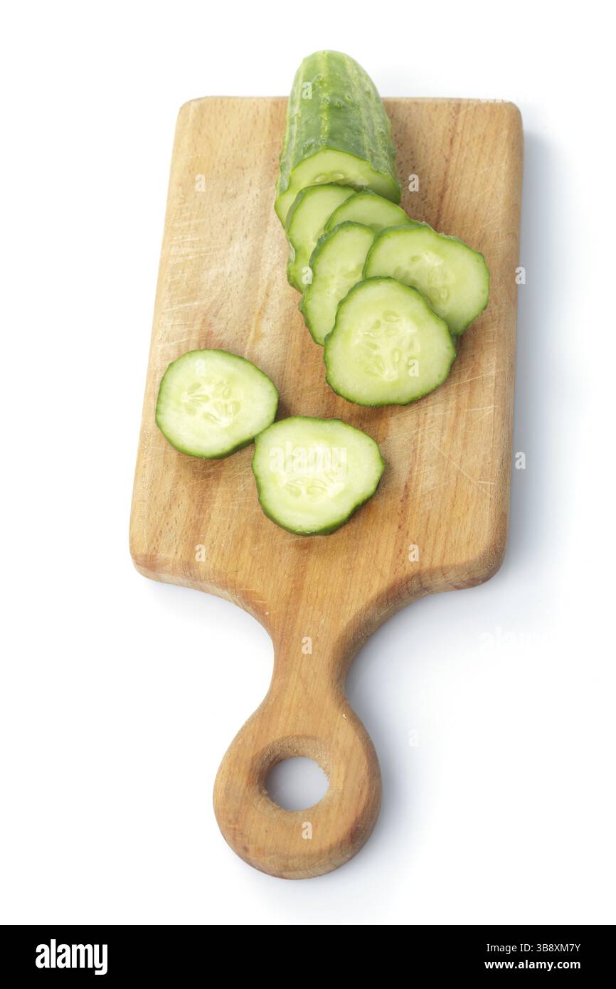 Gurkenscheiben auf den hölzernen Hartfaserplatten, isoliert auf weiss Stockfoto