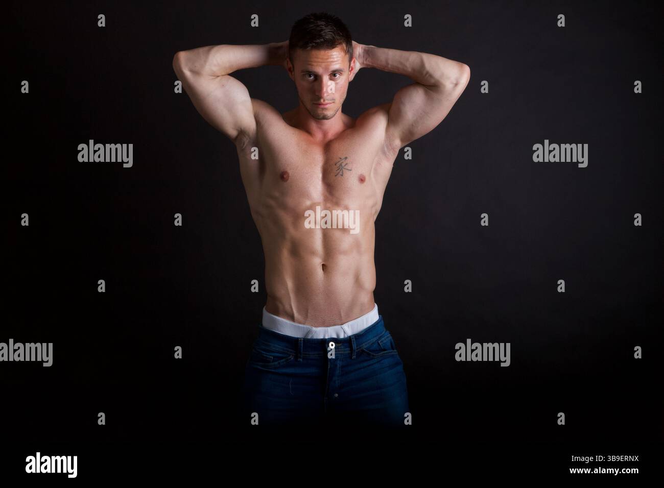 Männliches Modell mit Händen hinter dem Kopf Stockfoto