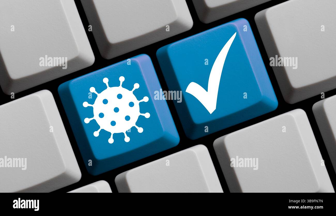 Häkchen und Coronavirus-Symbol auf Computertastatur Stockfoto