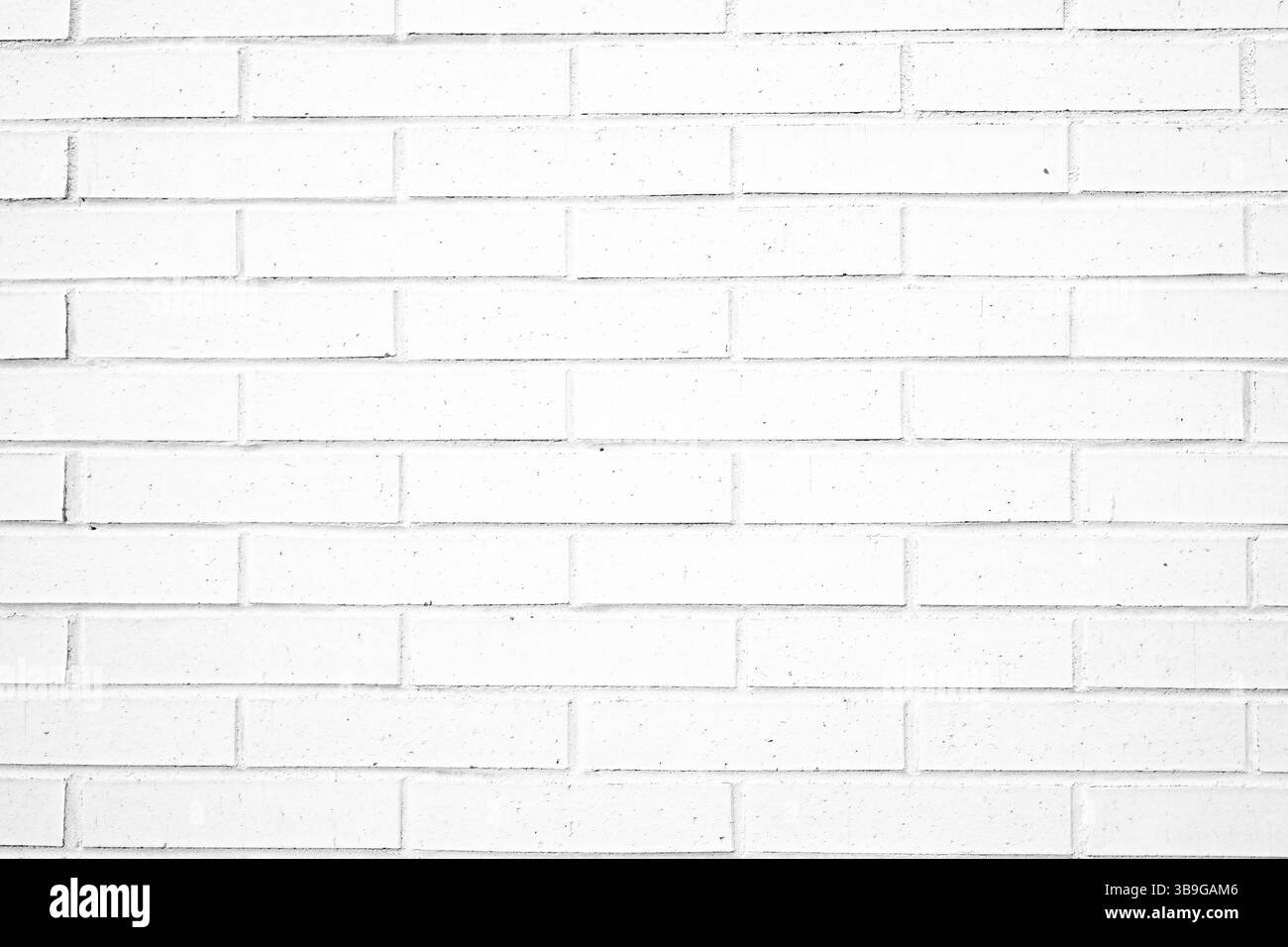 Nahaufnahme einer weißen Ziegelwand mit einer detaillierten Textur, die für zeitgenössische Architekturkonzepte geeignet ist. Stockfoto