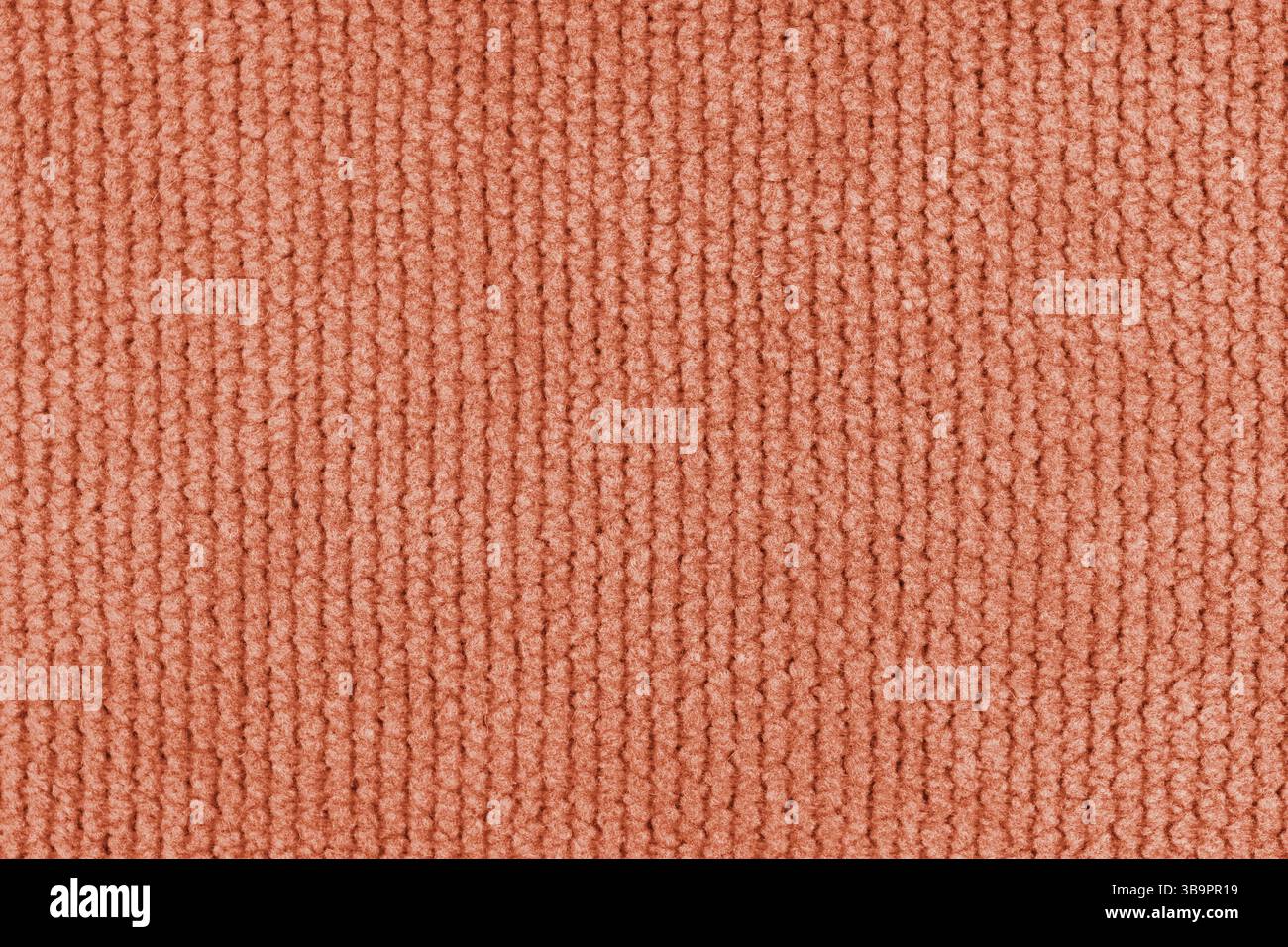 Textur aus Velours-Jacquard-Stoff in Orange, grob gewebt in Nahaufnahme, Makrogeweben. Textilhintergrund, Möbel Textilmaterial, Tapete, Backdro Stockfoto