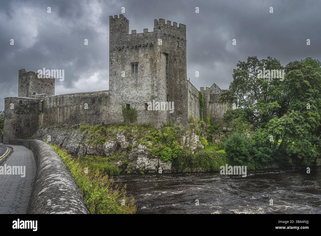 Cahir Castle aus dem 11. Jahrhundert am Ufer des Suir River in der Stadt Cahir mit dramatischem Sturmhimmel im Hintergrund, County Tipperary, Irland, Europa Stockfoto