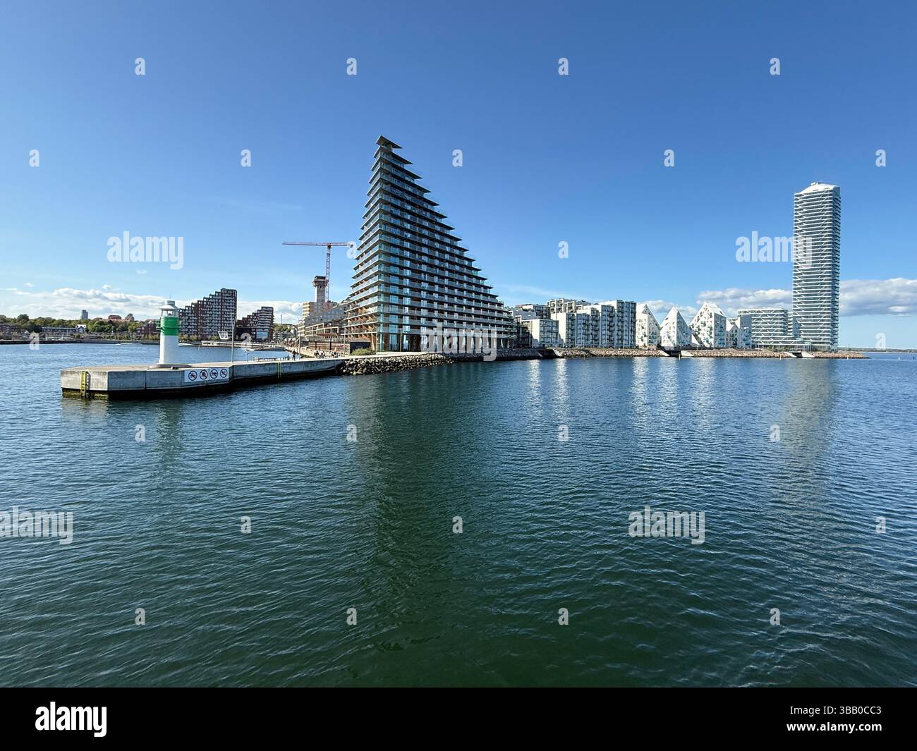 Blick auf das Land der modernen Apartmentgebäude am Wasser, einschließlich des Eisbergs und des Leuchtturms, Aarhus, Jütland, Dänemark Stockfoto