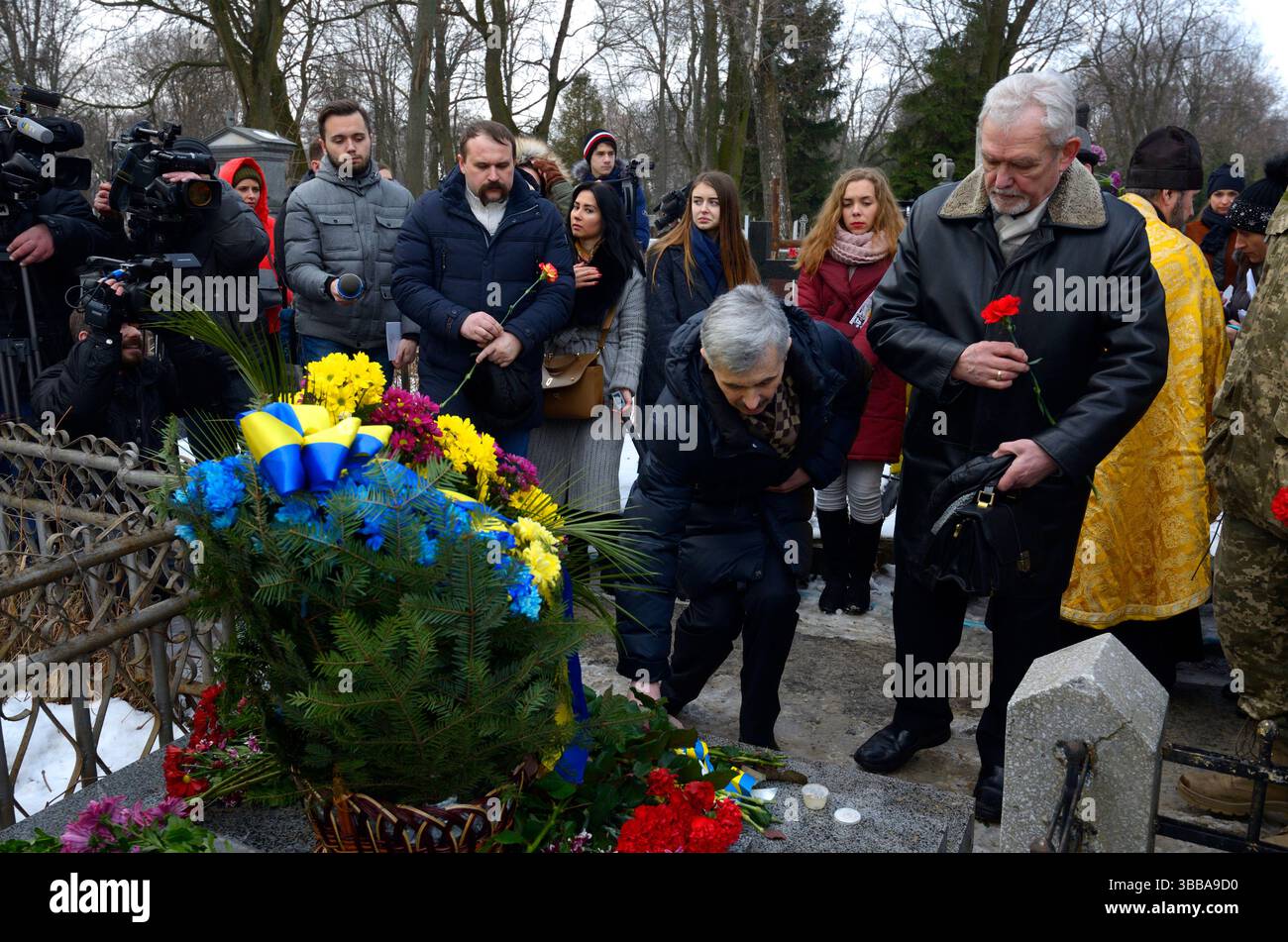Die Leute haben Blumen auf ein Grab von Kruty Heroes gelegt. Die Schlacht bei Kruty 1918, als ukrainische Kadetten die Rote Armee stoppten. Januar 2018. Friedhof Lukyanivske Stockfoto