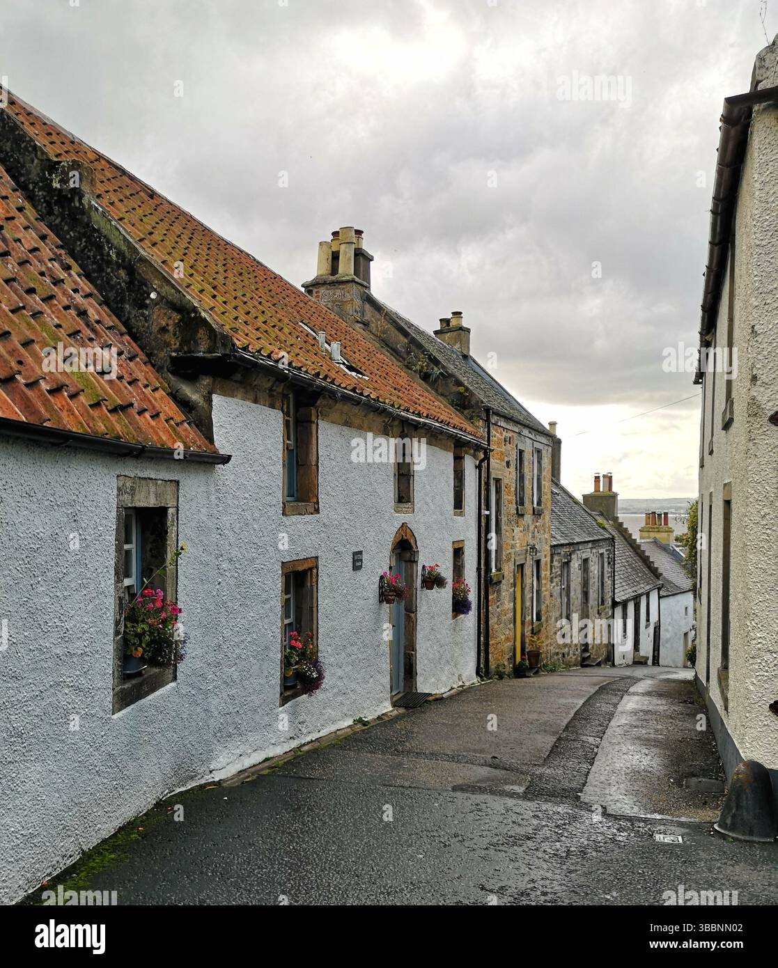 Culross, Fife, Schottland. Beispiel einer Burghof aus dem 17. Und 18. Jahrhundert mit malerischen Häusern, Kopfsteinpflasterstraßen, einem Marktkreuz und einer Abtei auf einem Hügel. Outlander-Set. - Smartphone-aufgenommenes Stockfoto