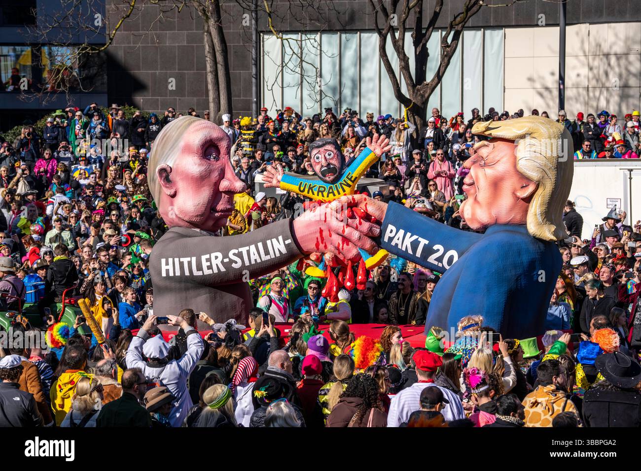 Rosen-Montag-Parade in Düsseldorf, schweben von Schwimmerbauer Jacques Tilly, Putin und Trump schütteln die Hände und zerschmettern den ukrainischen Präsidenten Zelensky im Prozess Stockfoto