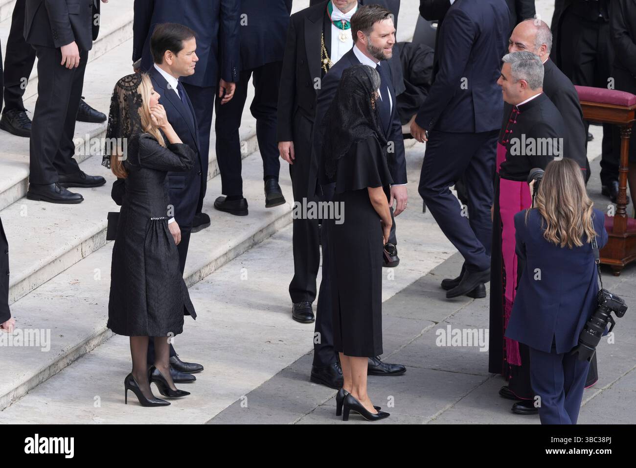 Secretary of State Marco Rubio, center left, his wife