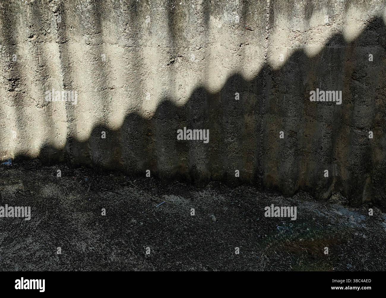 Betonmauer in der Gasse – Muster, Textur und Lichtspiel Stockfoto
