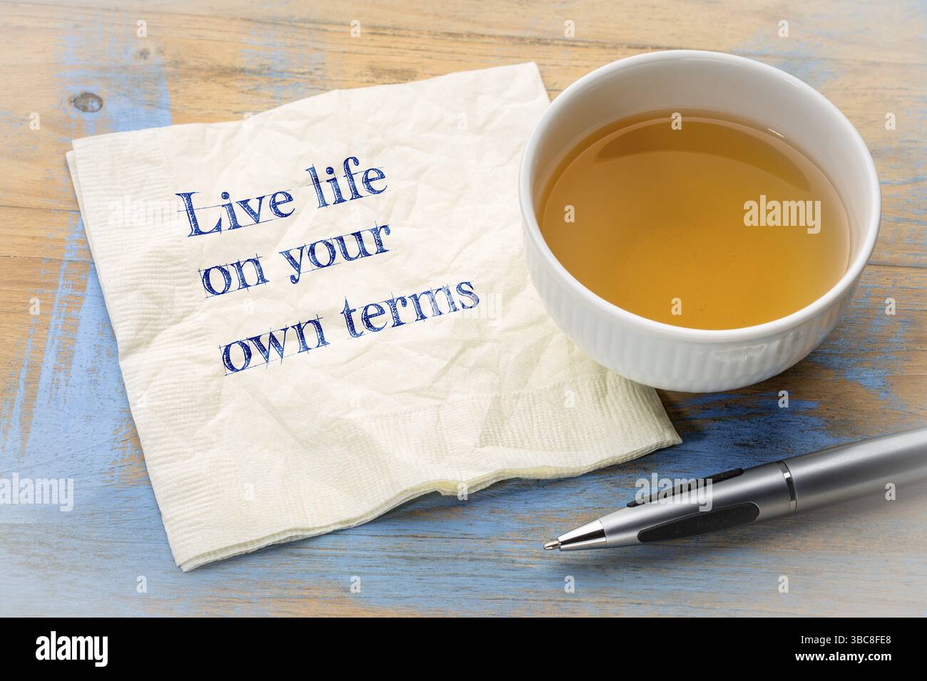 Leben Sie Ihr Leben nach Ihren eigenen Vorstellungen - inspirational Handschrift auf eine Serviette mit einer Tasse Tee Stockfoto