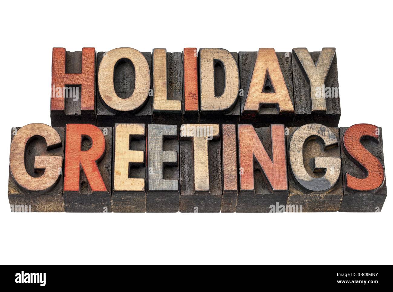 Weihnachtsgrüße Typografie - isolierter Text in Buchdruckholz, gebeizt mit Farbtinten Stockfoto