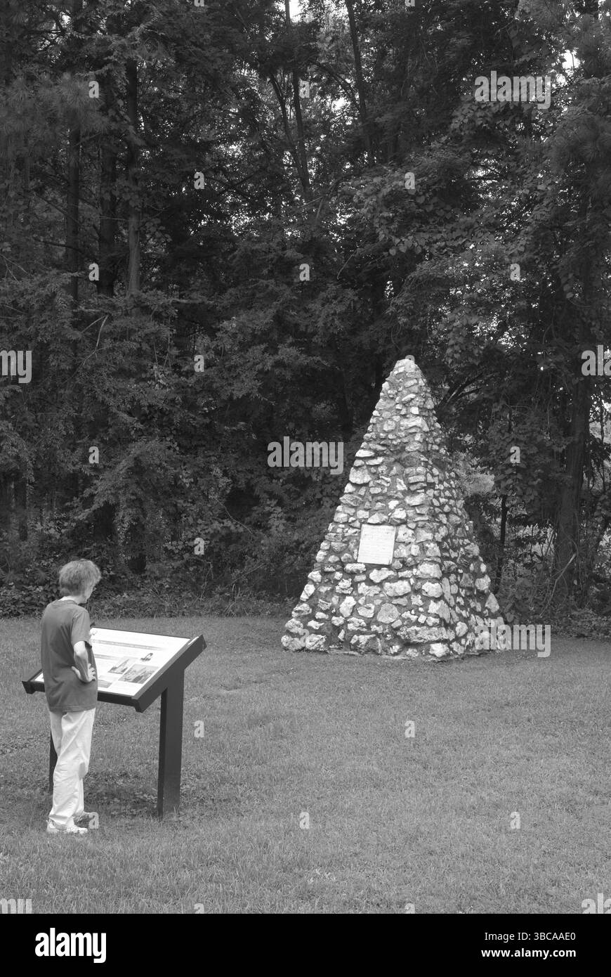 Eine kaukasische Frau liest einen Gedenkmarker auf dem ursprünglichen Gehöft von Präsident James K. Polk in der Nähe von Charlotte, North Carolina, USA. Stockfoto