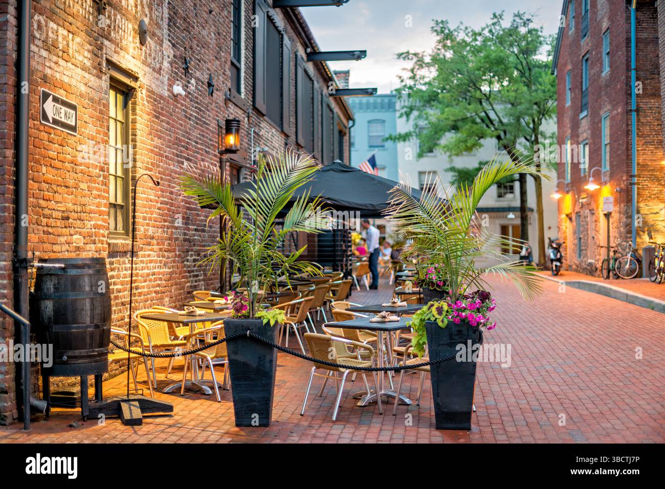 Virtue Feed and Grain Restaurant mit Sitzplatz im Freien Alexandria Virginia // ALEXANDRIA, Virginia – Sitzplätze im Restaurant Virtue Feed and Grain in der Altstadt von Alexandria. Das Restaurant befindet sich in einem renovierten Lagerhaus aus dem 19. Jahrhundert, das einst als Futter- und Getreidelager diente. Gäste können im Freien speisen. Das Hotel liegt nur einen Block vom Potomac River Waterfront an der 106 South Union Street entfernt und ermöglicht es Gästen, Mahlzeiten zu genießen und gleichzeitig den historischen Charme der Altstadt von Alexandria zu erleben. Stockfoto