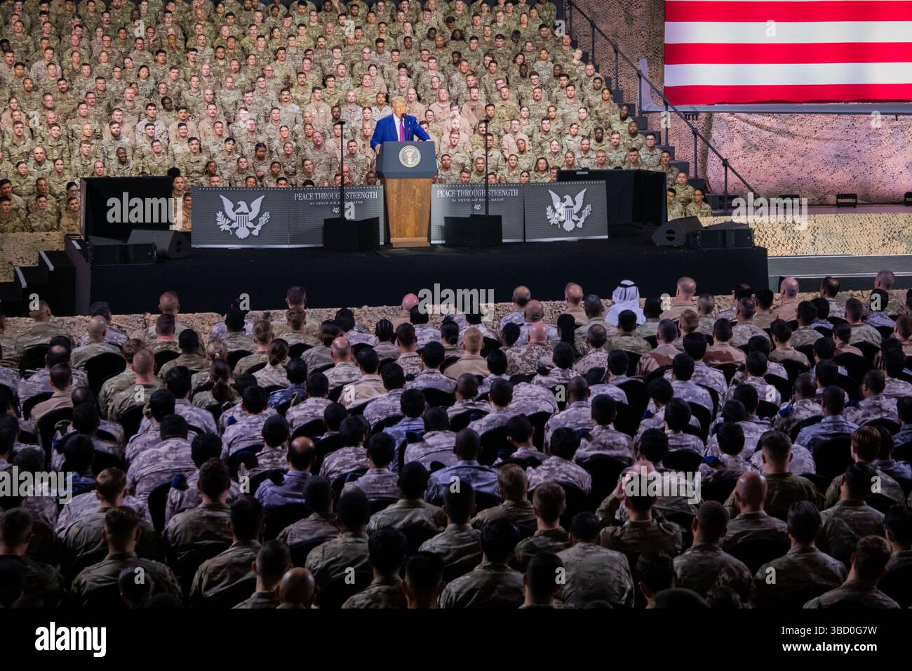 Präsident Donald J. Trump spricht am 15. Mai 2025 vor US-Truppen, Koalitionspartnern und katarischen Bürgern auf der Al Udeid Air Base in Katar. Trump tourte durch Saudi-Arabien, Katar und die Vereinigten Arabischen Emirate, um die Beziehungen zu den Partnern der Koalition und des Nahen Ostens zu stärken. (Foto der U.S. Air Force von Staff Sgt. Sean Moriarty) Stockfoto