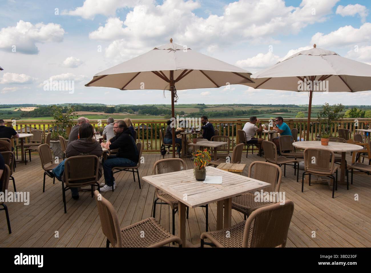 Die Terrasse mit Blick auf das Windrush Valley in Jeremy Clarkson's Pub, The Farmer's Dog, in den Cotswolds, Großbritannien. Stockfoto