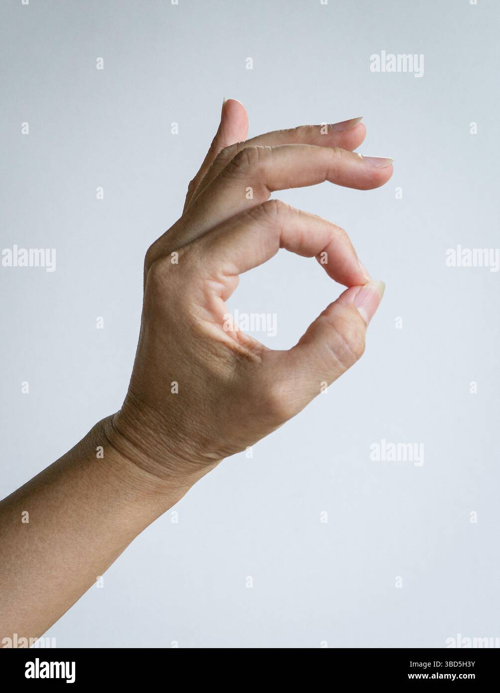 Frau Hand in OK Geste. Isoliert auf weißem Hintergrund. Stockfoto