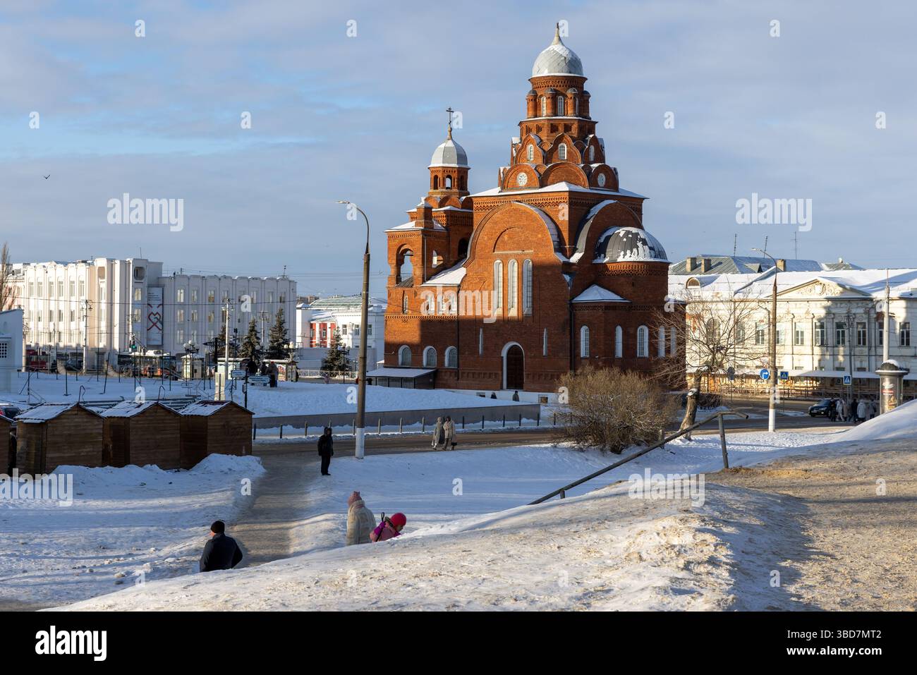 Wladimir, Russland - 5. Januar 2025: Stadtlandschaft mit der Dreifaltigkeitskirche. An einem Wintertag laufen die Leute auf der Straße Stockfoto