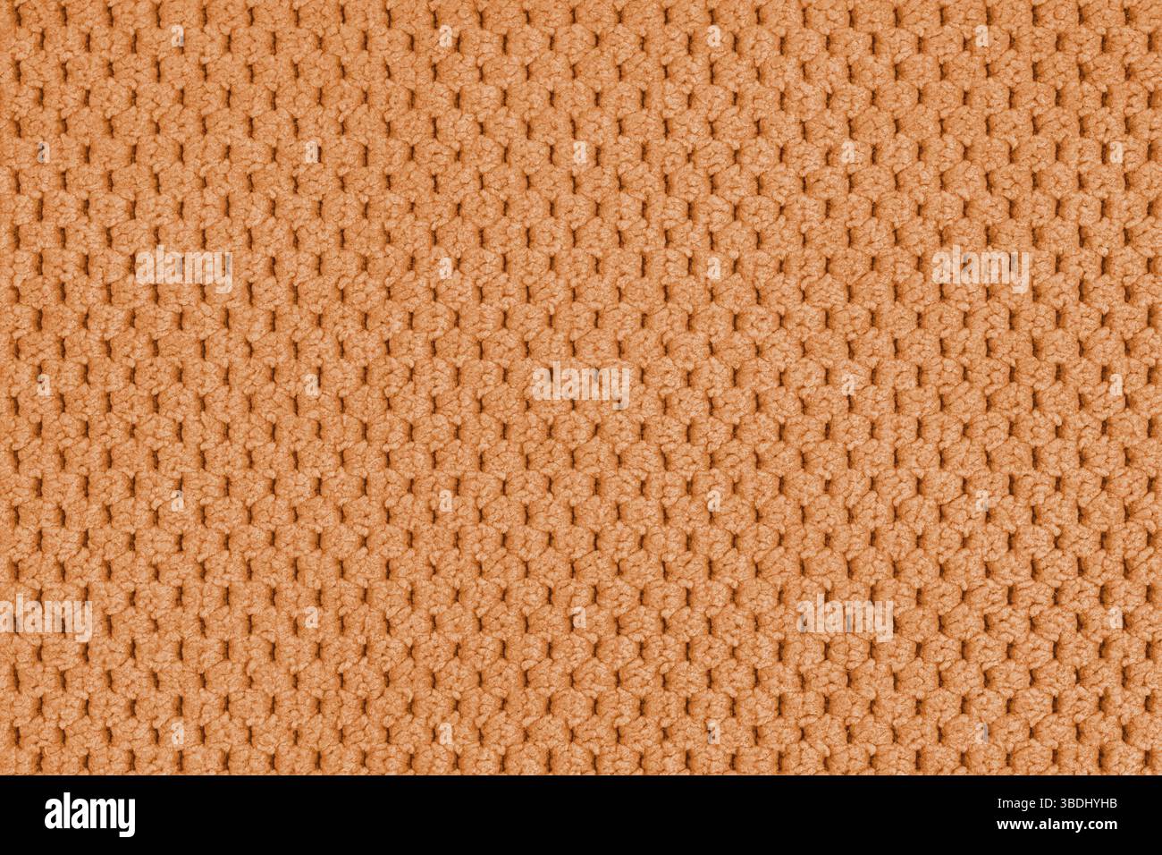 Einfarbiger orangefarbener Veloursbezug, flauschiger Jacquard mit Makro, geschlossener Muster Webstruktur Hintergrund, Textiloberfläche aus Stoff. Hintergrundbild, Backdr Stockfoto