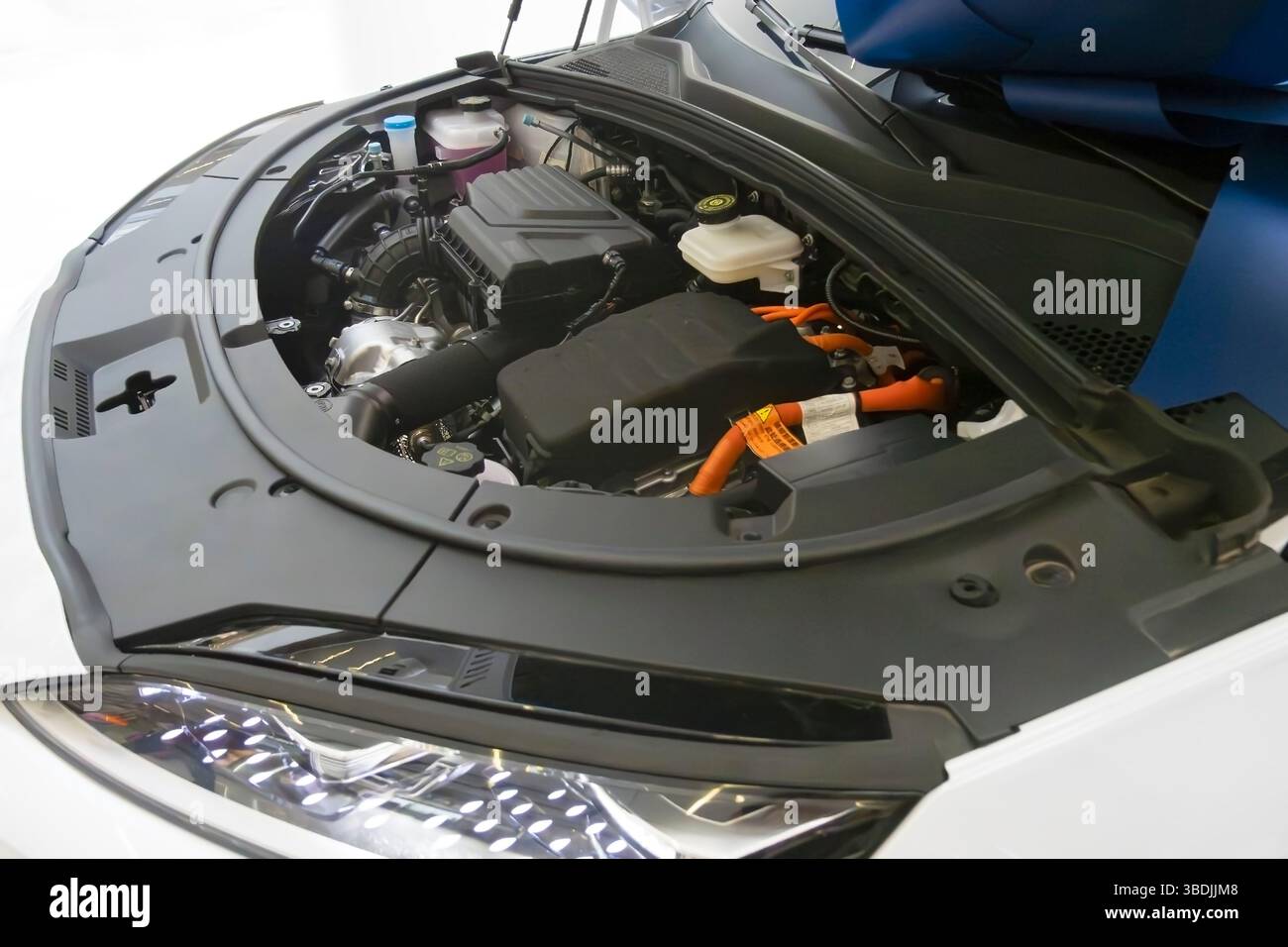 Chinesisches Elektroauto BYD mit geöffneter Motorhaube, das den Motor im Ausstellungsraum zeigt Stockfoto