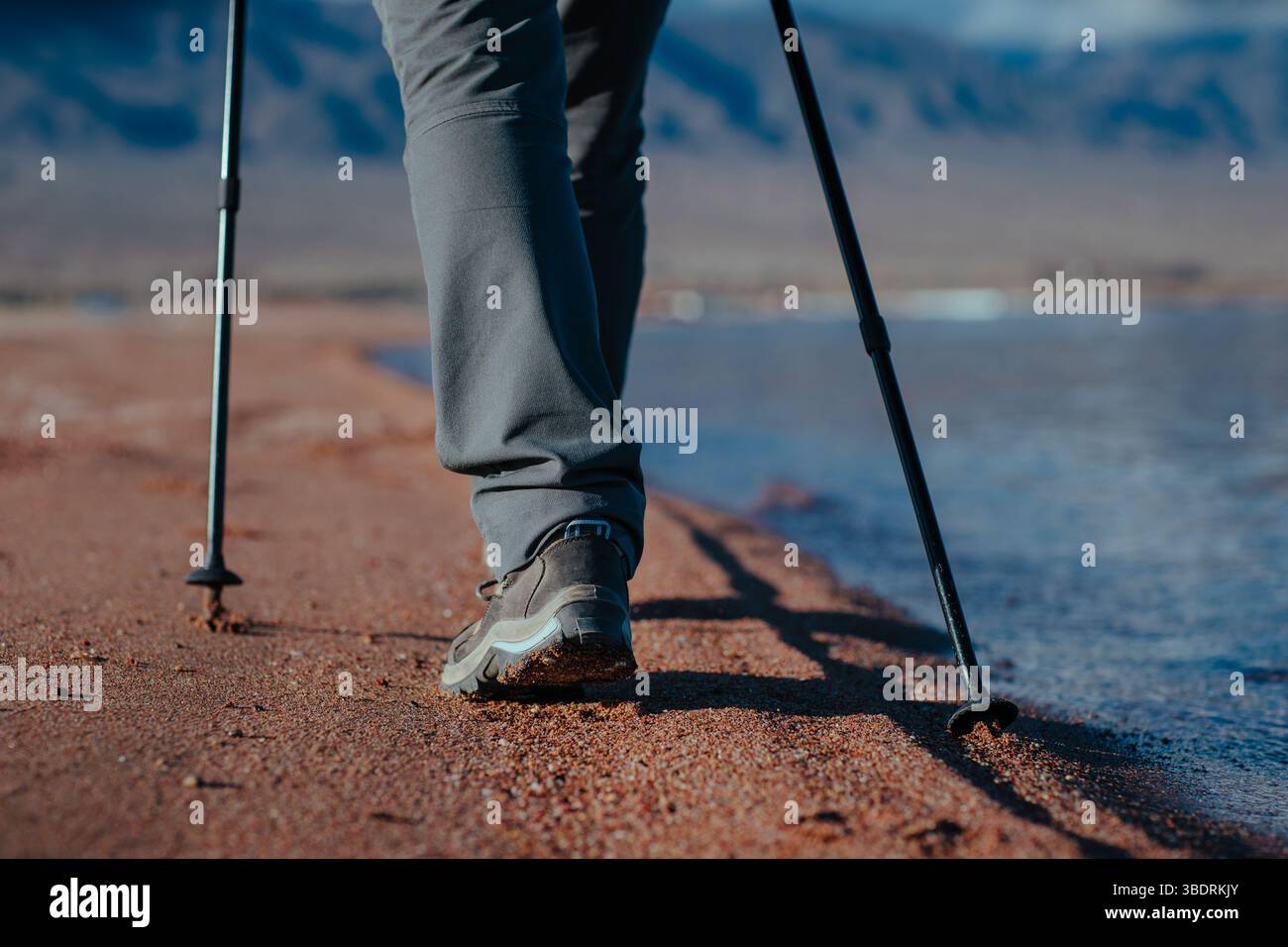 Frau läuft entlang des Sandufers des Sees, Beine aus nächster Nähe Stockfoto