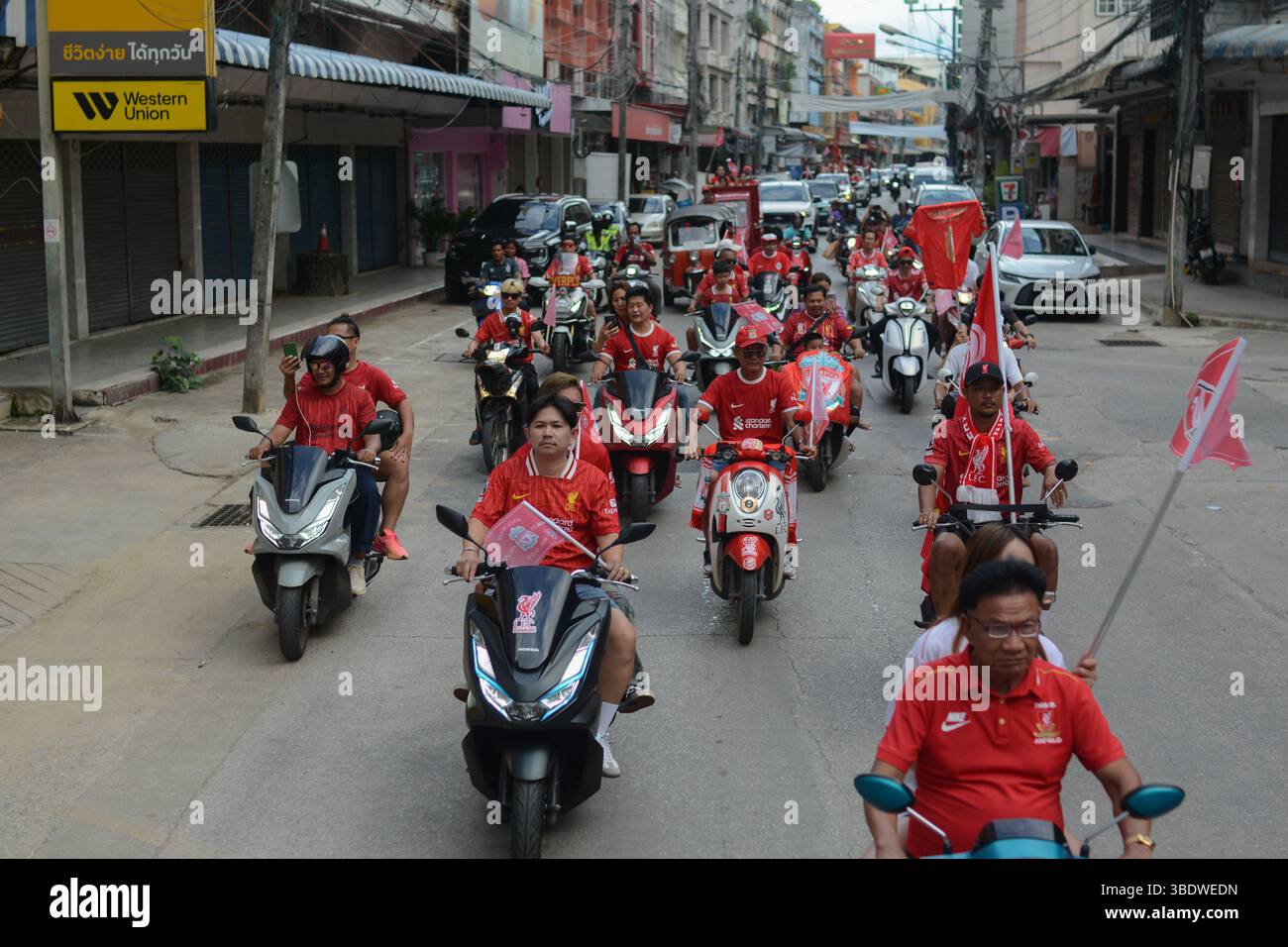 Mae Sot, Thailand. Mai 2025. Fans des FC Liverpool fahren Motorräder und Motorroller durch die Straßen von Mae SOT, schwenken Flaggen und feiern den Titelgewinn ihrer Mannschaft in der Premier League. Am 25. Mai 2025 hielten in Mae SOT, Thailand, rund 150 begeisterte Fans des Liverpool FC eine lebhafte Siegesparade durch die Stadt ab, um den Titelgewinn der Premier League zu feiern. In einem lebhaften Konvoi von Autos und Motorrädern umkreisten die Fans die Stadt und schwenkten Liverpool-Flaggen und würdigten stolz die triumphale Saison 2024-2025. Quelle: SOPA Images Limited/Alamy Live News Stockfoto