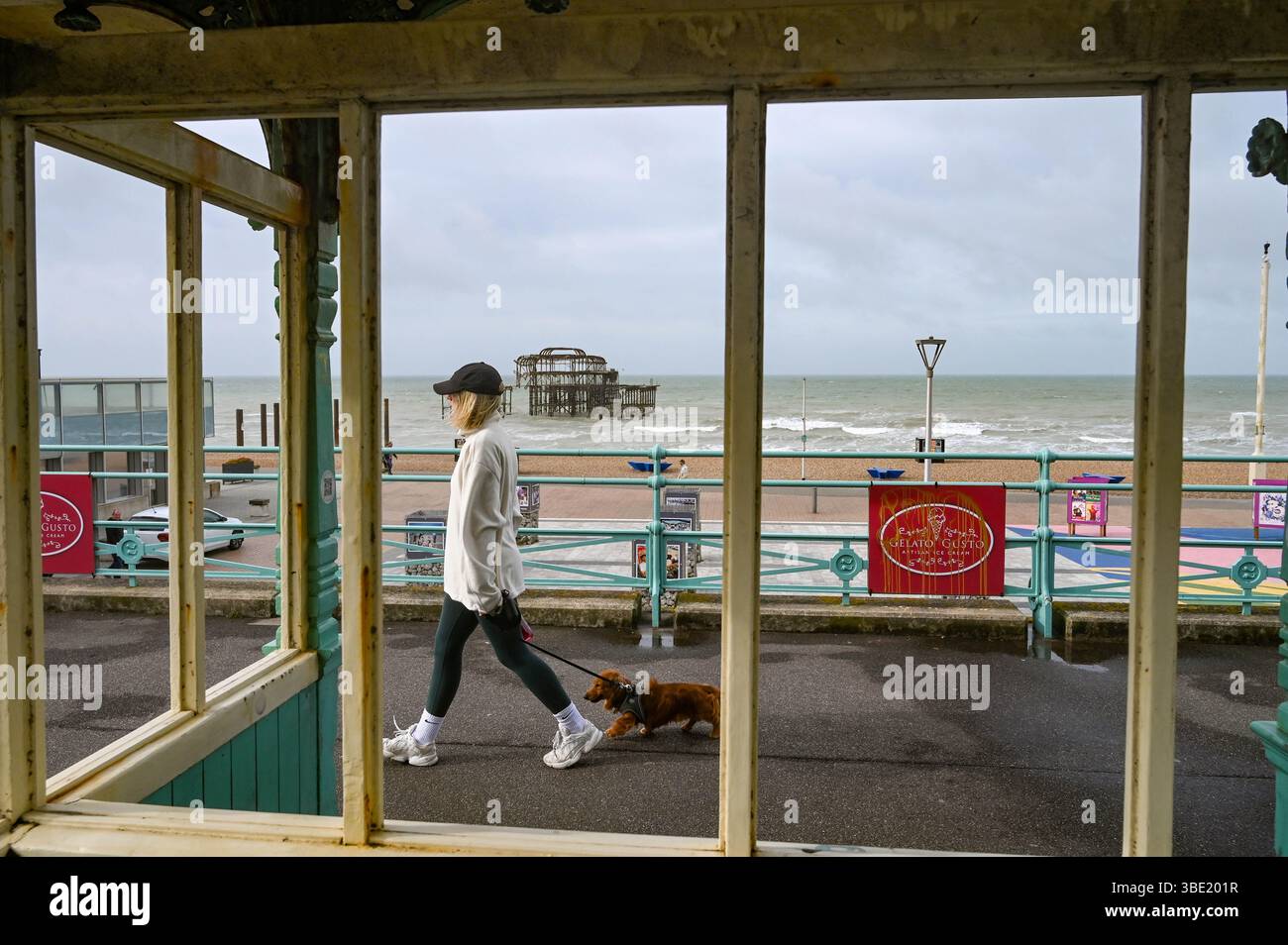 Brighton UK 27. Mai 2025 - Wanderer am frühen Morgen an einem windigen Morgen entlang der Brighton Küste, da unruhiges Wetter für Großbritannien prognostiziert wird: Credit Simon Dack / Alamy Live News Stockfoto