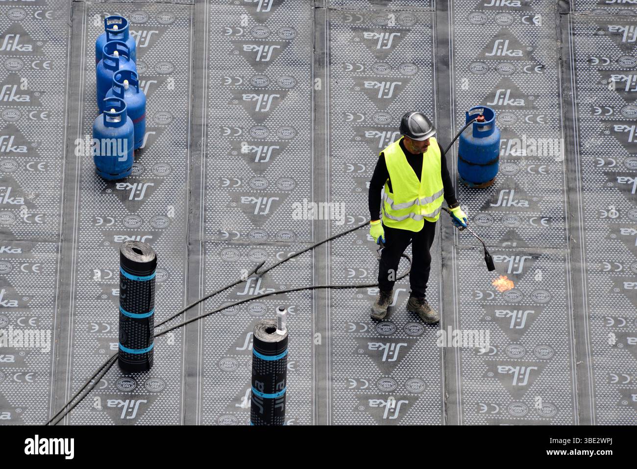Arbeiter, der auf einer Baustelle Dämmstoffe auf einem Fundament verlegt und sich auf die Wohnentwicklung in Sofia, Bulgarien, Osteuropa, Balkan, EU vorbereitet Stockfoto