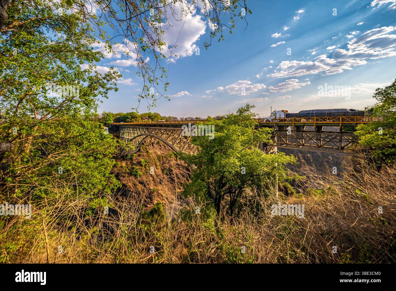 Simbabwe, Matabeleland septentrional Provinz, Hwange District, Victoria Falls National Park, Stadt Victoria Falls, die Victoria Falls Bridge überquert den Sambezi River zwischen Simbabwe und Sambia, umgeben von dichter, üppiger Vegetation. Stockfoto