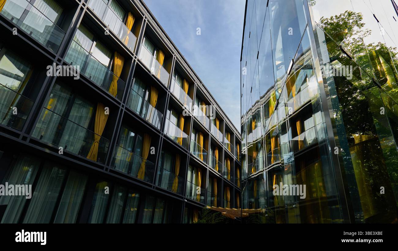 Das moderne Gebäudedesign zeigt reflektierendes Glas und farbenfrohe Vorhänge Stockfoto