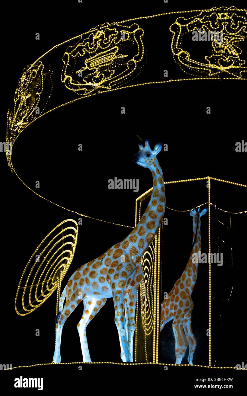 Ein detaillierter Blick auf das beleuchtete Karussell mit Tierfiguren und Goldmustern erstrahlt bei Nacht an der östlichen Mangrove in Abu Dhabi, den Vereinigten Arabischen Emiraten. Stockfoto