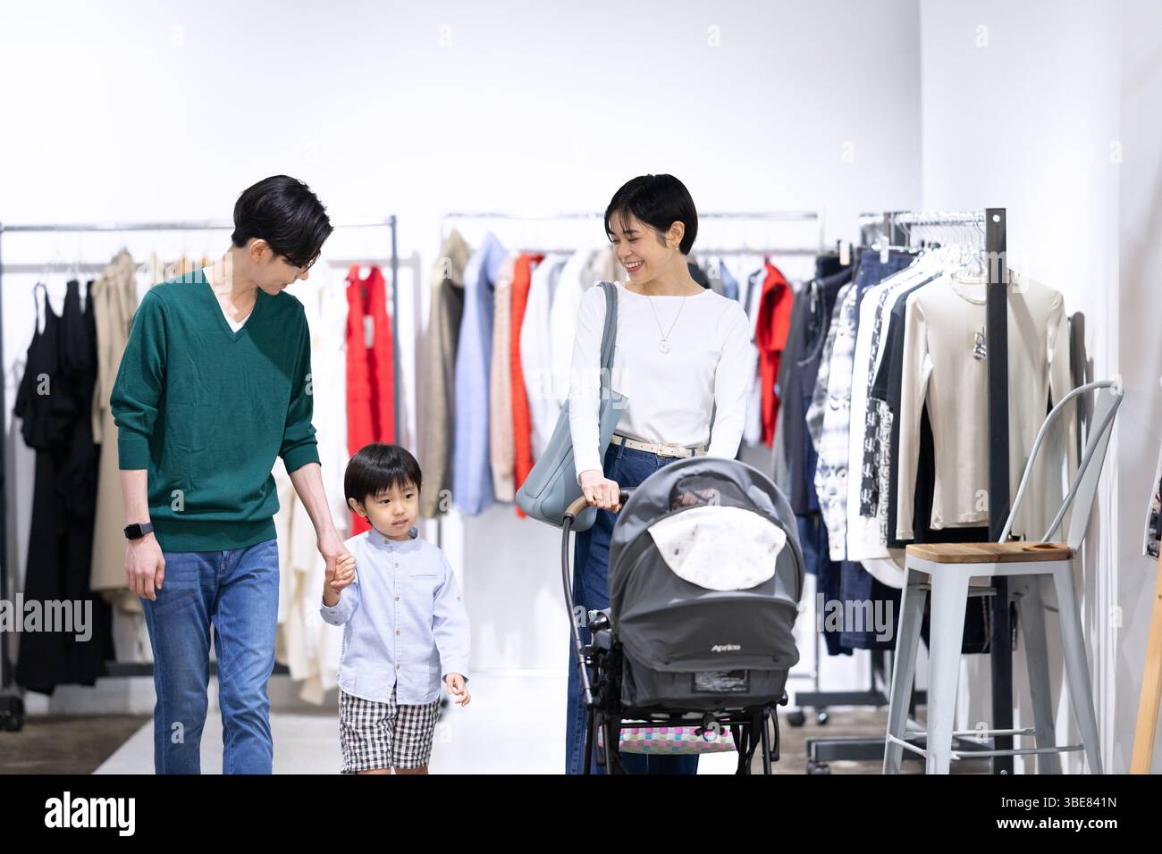 Familie schiebt einen Kinderwagen in einer Boutique Stockfoto