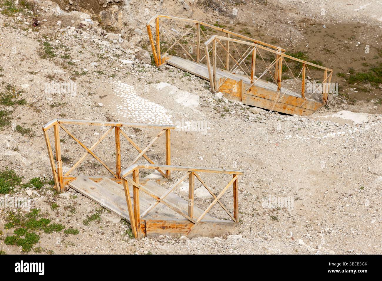 Hölzerne Treppenbrücken durchqueren eine felsige Landschaft und bieten eine Mischung aus Natur und Verarbeitung. Perfekt für Outdoor-Enthusiasten und Bauprojekte Stockfoto