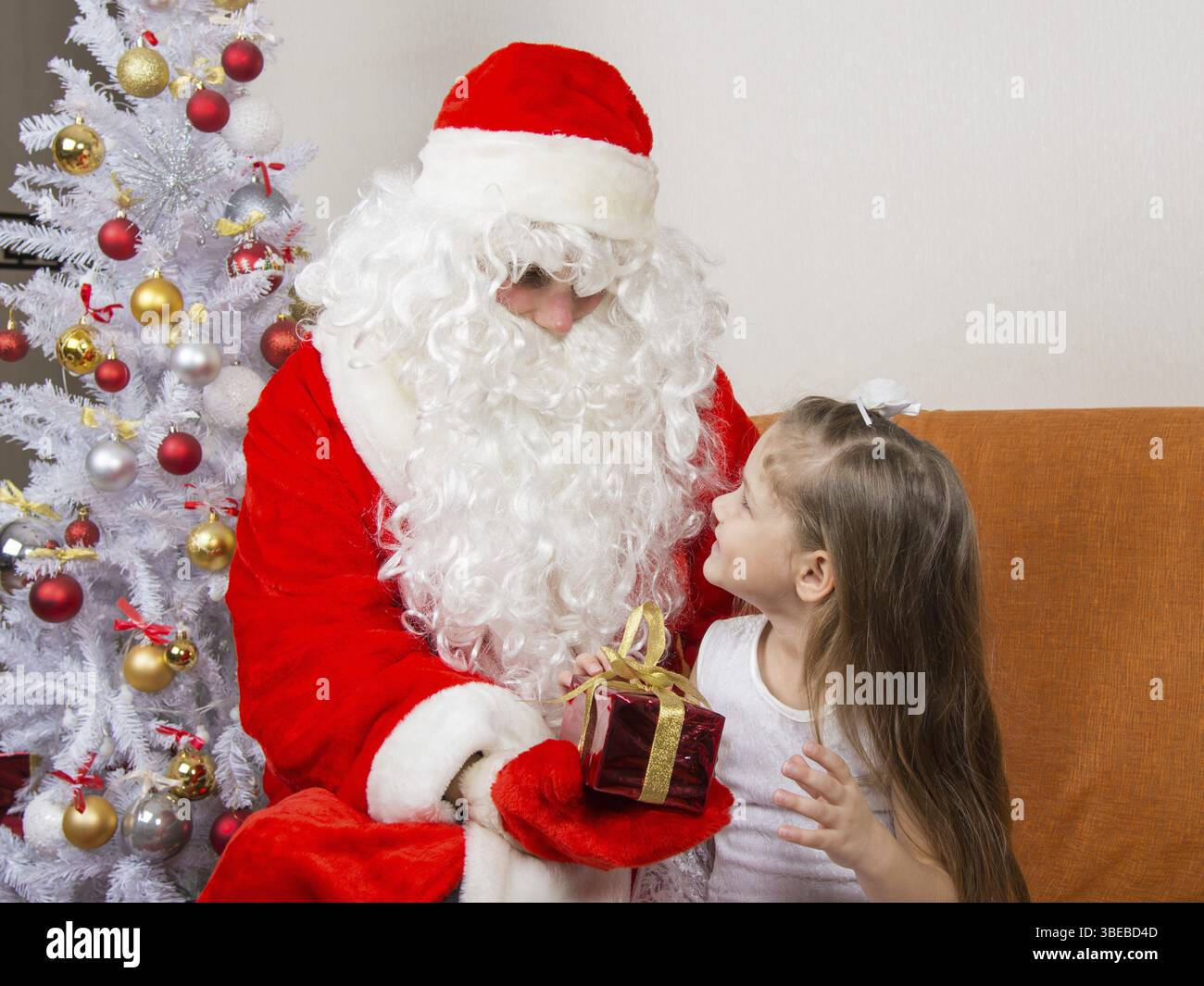 Santa Claus gibt ein Geschenk ein fünfjährigen Mädchens Stockfoto