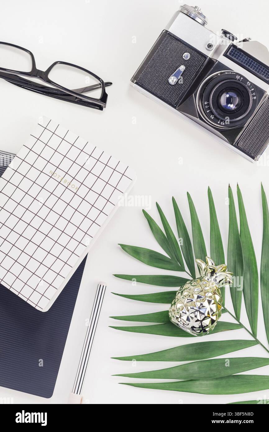 Ansicht von oben flach Büro Arbeitsplatz mit Schreibtisch gestalteten Design Bürobedarf, der von tropischen Palmen Blätter smartphone Kamera kopieren Raum schwarz weiß Hintergrund. Templa Stockfoto