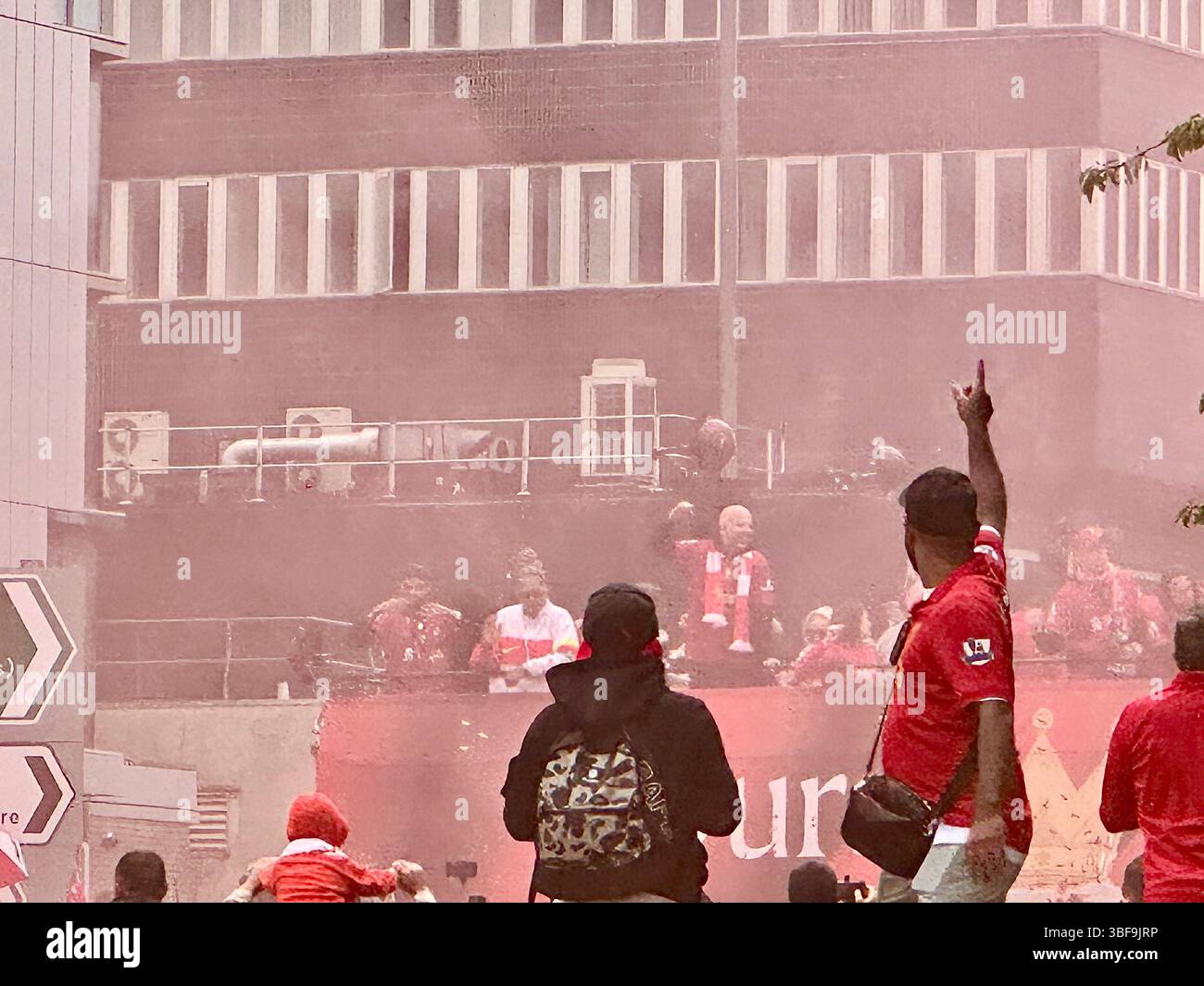 Fans winken am 25. Mai 2025 in Arne Slot, Virgil van Dijk und Teamkollegen im Liverpool Parade Bus durch roten Rauch auf der Hunter Street - Smartphone-aufgenommenes Stockfoto