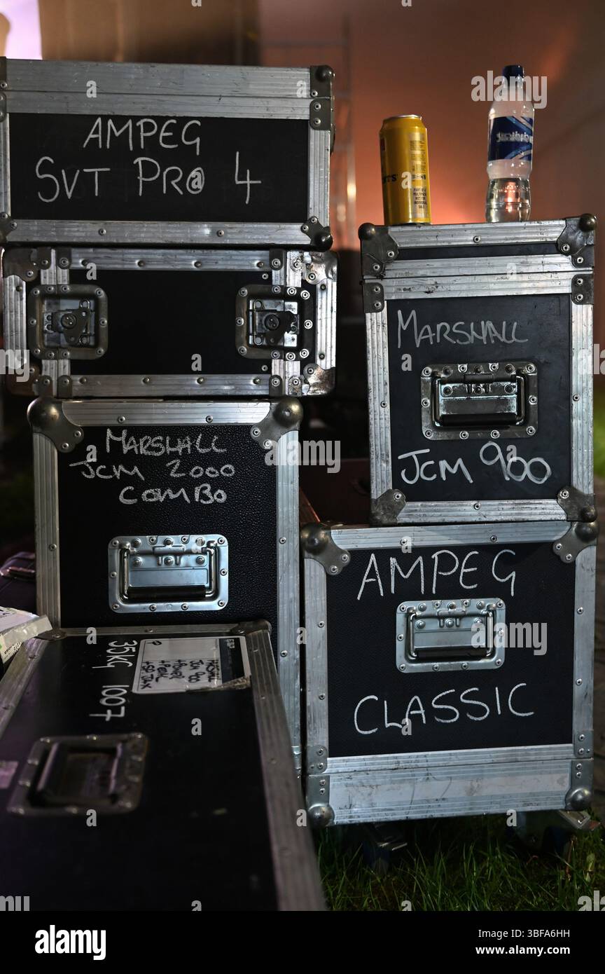 Generische Verstärkerflugkoffer mit der Bezeichnung Ampeg and Marshall, mit einer Flasche Wasser und einer Dose Bier, hinter der Bühne eines Rockfestivals in Schottland. Stockfoto