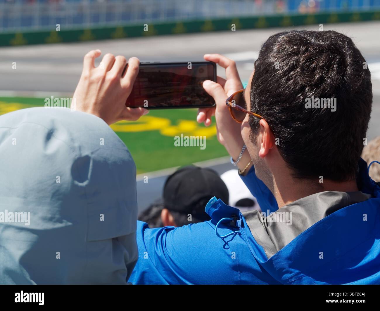 Der Zuschauer nimmt das F1-Rennen mit seinem Handy auf Stockfoto