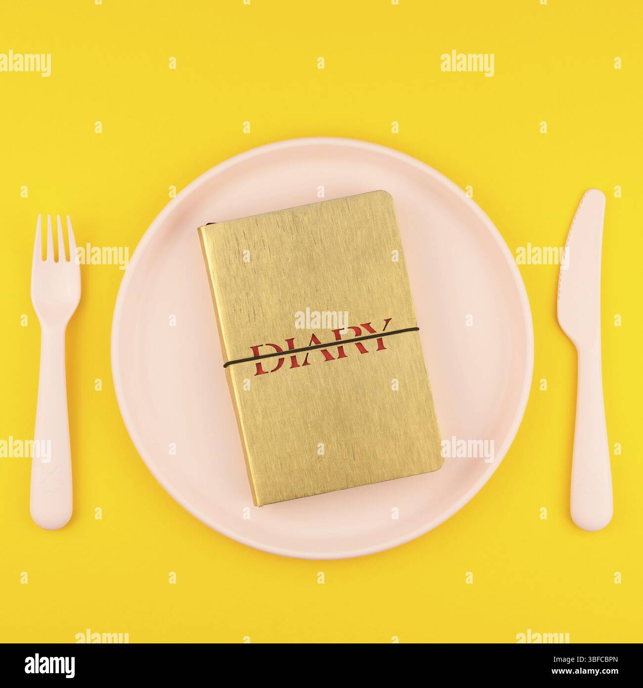 Kleine Liebe goldene Tagebuch Liebe Symbol Platte mit Plastikgeschirr kopieren Speicherplatz auf kräftigen gelben Hintergrund in der kreativen Minimal Style. Platz Konzept Val Stockfoto