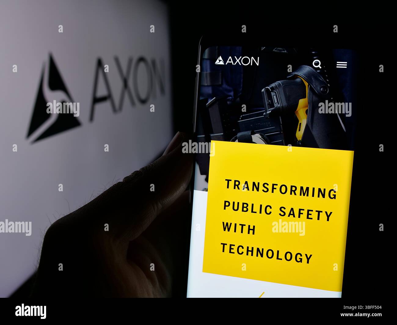 Stuttgart, Deutschland - 16.01.2025: Person, die ein Mobiltelefon hält, mit Webseite des US-amerikanischen Sicherheitsausrüstungsunternehmens Axon Enterprise Inc. Auf dem Bildschirm mit Logo. Stockfoto