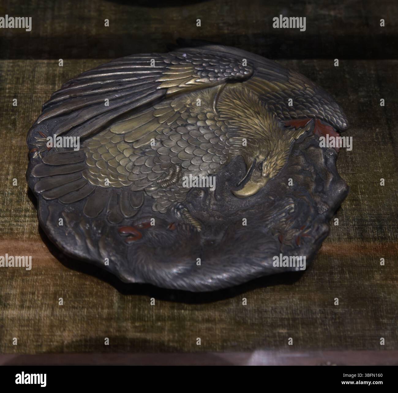 Japanische Bronzeschale im Tsuba-Stil mit Adlermotiv im Relief, ausgestellt im Stibbert Museum in Florenz, Italien. Stockfoto