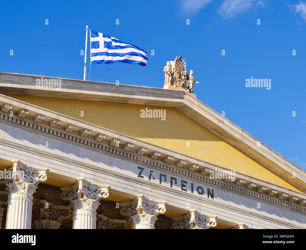 Griechische Flagge über dem Zappeion-Gebäude in Athen, mit klassischer Architektur und blauem Himmel Stockfoto Griechische Flagge über dem Zappeion-Gebäude in Athen, mit klassischer Architektur und blauem Himmel Stockfoto
