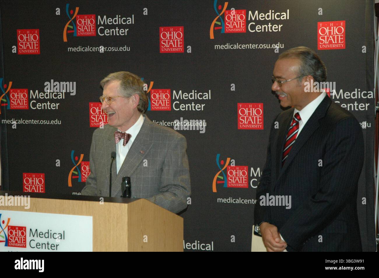 Im OSU Hospital East lacht Gordon Gee, während er an einem Rednerpult steht, mit Columbus Bürgermeister Michael Coleman an seiner Seite. Stockfoto