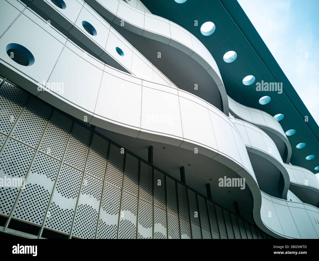 Entdecken Sie die komplizierten Details eines zeitgenössischen architektonischen Designs mit fließenden Linien und geometrischen Mustern, die ein beeindruckendes visuelles impa schaffen Stockfoto
