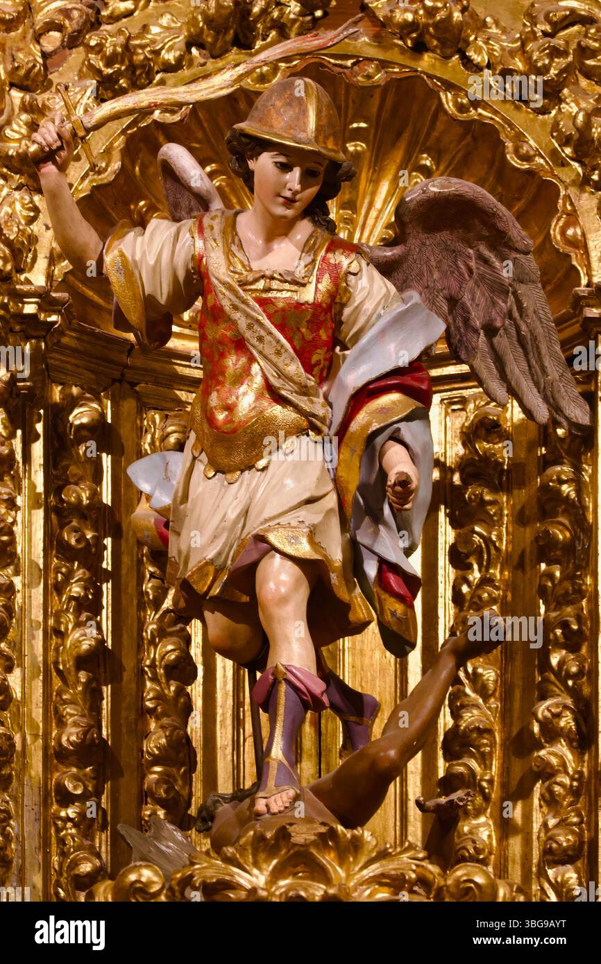 Eine Skulptur des Heiligen Michael, die ein Schwert auf Feuer schwindet, steht über dem Teufel in der Capilla de San Miguel Cáceres Co-Kathedrale der Heiligen Maria Caceres Spanien Stockfoto