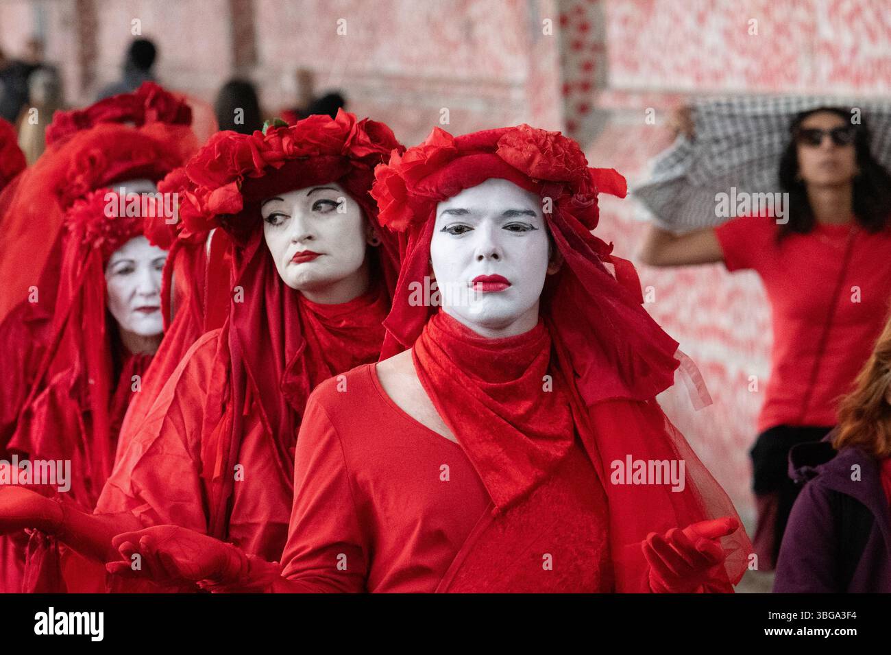 London, Großbritannien. 4. Juni 2025. Die Aktivistentruppe der Roten Rebellen-Brigade läuft entlang der Nationalen COVID-Mauer, gegenüber den Houses of Parliament, schließt sich palästinensischen Anhängern an, die das Parlament umgeben, und bildet eine "Rote Linie für Palästina", um die britische Regierung aufzufordern, Israels Krieg gegen Gaza zu unterstützen und stattdessen ein Waffenembargo und Sanktionen gegen Israel durchzusetzen. Die Veranstaltung erstreckte sich über Westminster und Lambeth Bridge, als Sir Keir Starmer Fragen des Premierministers im Unterhaus stellte. Quelle: Ron Fassbender/Alamy Live News Stockfoto