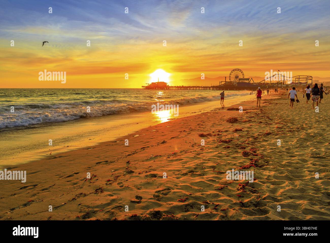 Sunset Landschaft von Santa Monica Pier spiegelt sich auf dem Strand Ufer. Santa Monica historisches Wahrzeichen, Pazifischer Ozean, Kalifornien, USA. Vergnügungspark wit Stockfoto